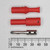 Three-piece assembly laid out disassembled: red plastic boot, ribbed red body with CE mark, and nickel-plated pin with two visible Allen-head set screws.