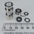 Nickel-plated connector body approx 30mm tall with white PTFE dielectric, knurled coupling ring, plus hex nut, center pin, rubber gasket, and two washers laid out unassembled.
