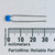Horizontal view of 222-J5A radial capacitor next to a millimeter ruler.