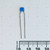 Vertical view of 222-J5A radial capacitor positioned above a metric ruler.