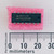 Texas Instruments SN74LS393N DIP-14 integrated circuit on pink foam next to a millimeter ruler.