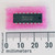 Top view of Texas Instruments SN74LS14N DIP-14 IC on pink foam next to a millimeter ruler.