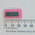 Top view of Analog Devices AD 1860N 16-pin DIP IC on pink foam next to a metric ruler.