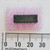 Top view of Mitsubishi M74LS04P DIP-14 integrated circuit on pink foam with a metric ruler.