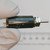 Close-up of Spectrol 162-11104 precision potentiometer held in gloved hand.