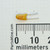 Tantalum capacitor alongside a millimeter ruler for scale.