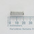 Century Spring K-9ØCS compression spring shown next to a millimeter ruler.