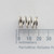 Side view of Century Spring S-1401 CS compression spring on a millimeter grid.