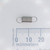Lee Spring Co. LE-10B-01-S extension spring next to a millimeter ruler.