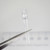 A-1155 clear 5mm through-hole UV LED held in tweezers.