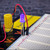 Illuminated 5mm UV LED glowing violet, inserted into a breadboard for demonstration of 410-415nm output.