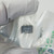Close-up of NTE976 DIP-8 IC through packaging showing part number and date code.