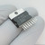 Angled view of a Unitrode UC3622V showing the 15 staggered leads.
