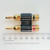 Stinger DBP-BLK-S dual banana plug alongside a millimeter ruler.