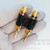 Angled view of Phoenix Gold DBP-BLK-PG dual banana plug showing wire entries.