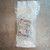 Full package view of SMC SY7000-27-2T in sealed bag.