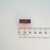 ITT 14473557 integrated circuit on pink foam next to a metric ruler.