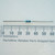 Unbranded 18.7K.25W-R 1/4 watt resistor shown against a millimeter ruler.