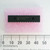 Microchip PIC16F876-20/SP 28-pin DIP microcontroller on protective pink foam with a millimeter ruler.