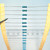 Tape strip of through-hole axial lead resistors with blue bodies and color bands.
