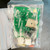 Sealed parts bag showing reverse side of circuit board and various electronic components.
