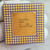 Underside of Intel A80486DX-33 showing pin grid array with bent pins and central gold cap.