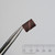 Side profile of Even Cut 14103 abrasive band held in tweezers.
