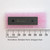 Microchip PIC18F452-I/P DIP microcontroller on pink foam next to a metric ruler.
