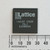 Lattice ispLSI 1032E 70LJ integrated circuit shown with a millimeter scale.