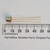 GE 2N491 transistor with gold-plated leads shown next to a millimeter scale.