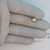 Gloved hand holding a GE 2N491 transistor showing gold leads and metal can profile.