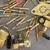 Close-up of gold-plated connector pins, transistor header, and RF fittings in electronic scrap lot.