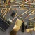 Close-up of IC socket, gold-plated sheet scrap, and pins in scrap lot.