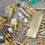 Close-up of gold-plated scrap including Motorola MC1438R transistor and pins.