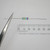 Close-up of NTE HW443 axial resistor held in tweezers.