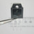 Close-up of Fairchild SFH9140 power transistor held in tweezers.