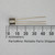 Side view of Motorola ROG05 metal can transistor with gold leads against a millimeter ruler.