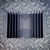 Bottom view of black heatsink showing mounting holes and heat fin profile.