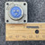 Amphenol 97-3102A-16S-6S connector square flange measured with a ruler at approximately 1.25 inches across.
