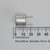 Side view of ultrasonic sensor positioned beside a millimeter scale.