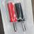 Close-up of one red and one black RadioShack 274-721 banana plug in clear blister packaging.