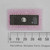 Texas Instruments 27C256-150 EPROM chip shown alongside a millimeter ruler for scale.