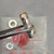Side view of IPC 74868-UG-1016/U connector body held with tweezers.