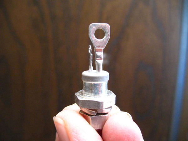 SCR stud mount device with ring terminal and two spade terminals, showing clean, bright metal finish and no visible corrosion.
