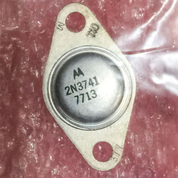 Motorola 2N3741 TO-66 metal-can power transistor with two-hole diamond flange on a pink crinkled surface