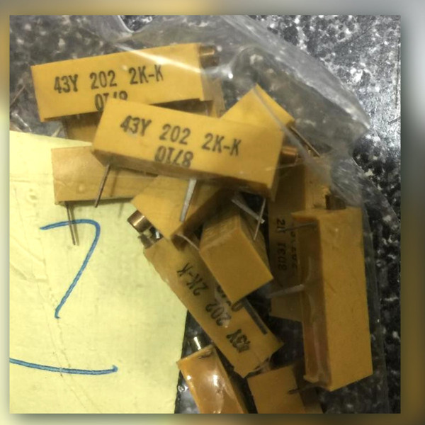 Yellow 43Y 202 2K-K trimmers with gold-colored adjust screws on a speckled surface
