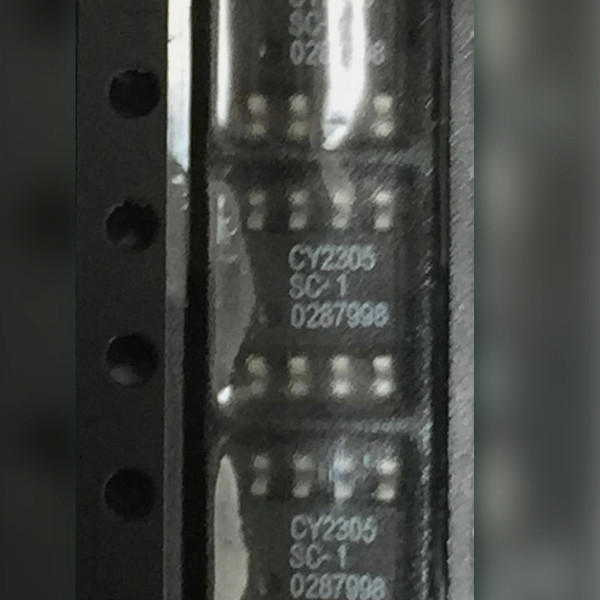 Three 8-pin SOIC chips in a row, two legibly marked CY2305 SC-1, close view