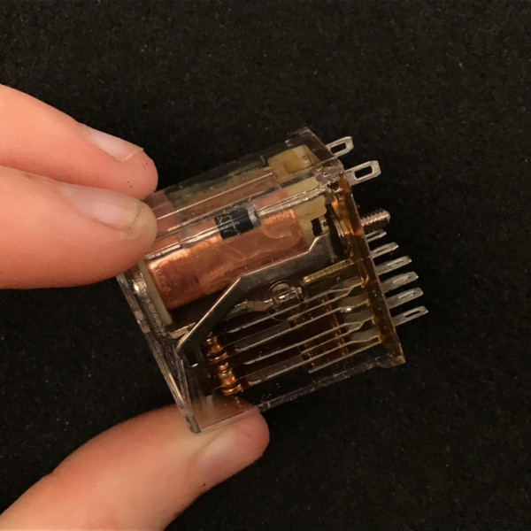 Potter and Brumfield R10-E1W4-115V relay side view, clear case, copper coil and blade terminals