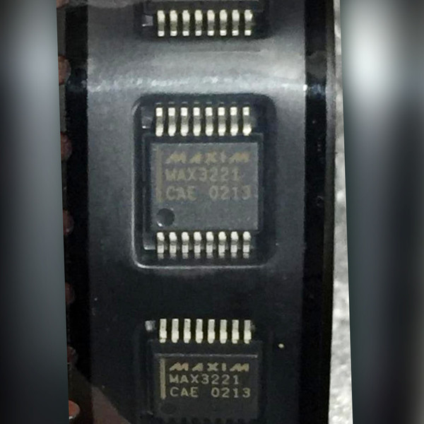 Three Maxim MAX3221 CAE 16-pin SSOP RS-232 transceiver chips held between fingertips
