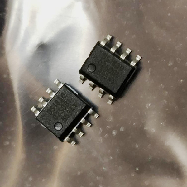 Two 8-pin SO surface-mount reset sequencer chips on a crinkled silvery surface